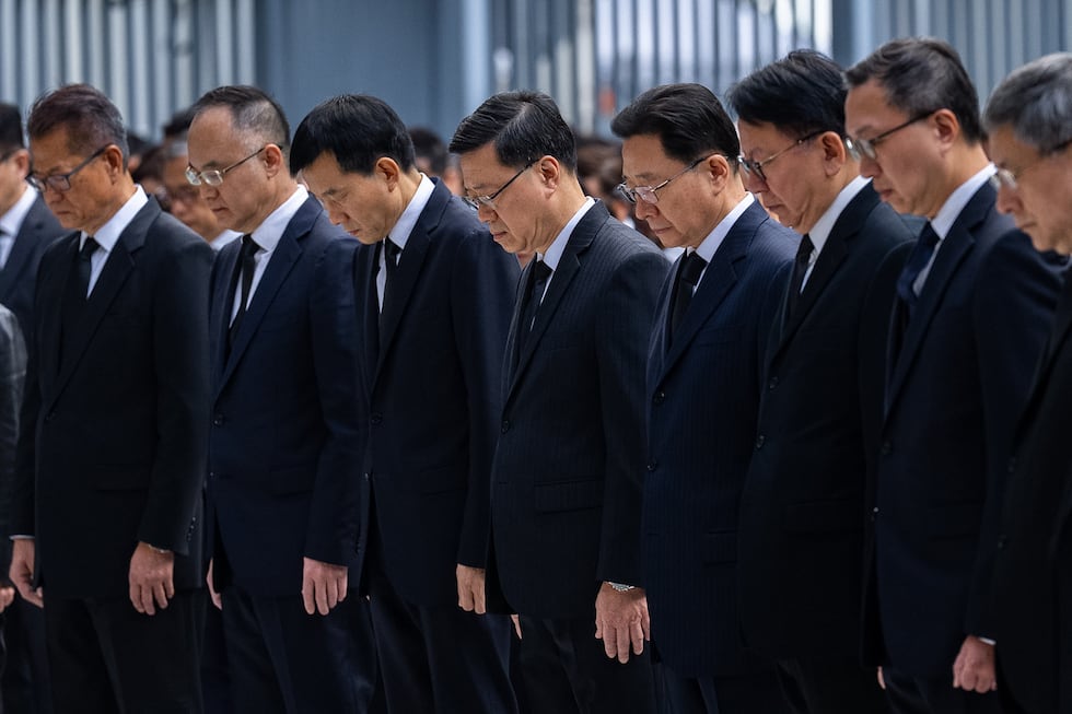 Hong Kong Chief Executive John lee, center and other officers observe a moment of silence for...