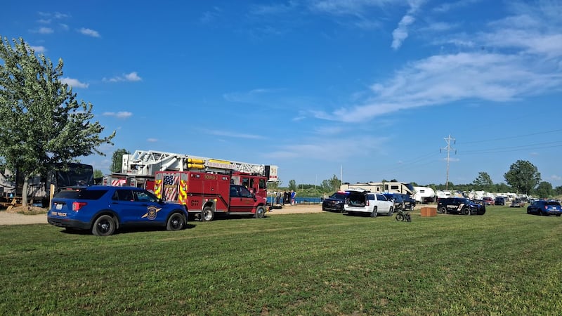 Authorities say a father drowned after he and his 8-year-old son tried to swim across a lake...