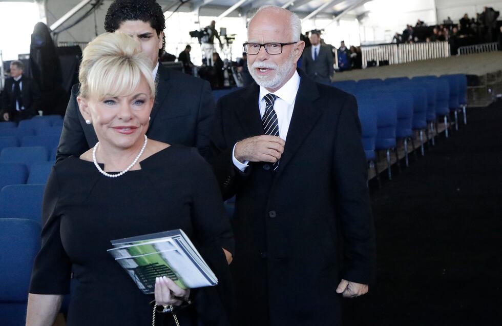 FILE - In this March 2, 2018 file photo, Televangelist Jim Bakker, right, walks with his wife...