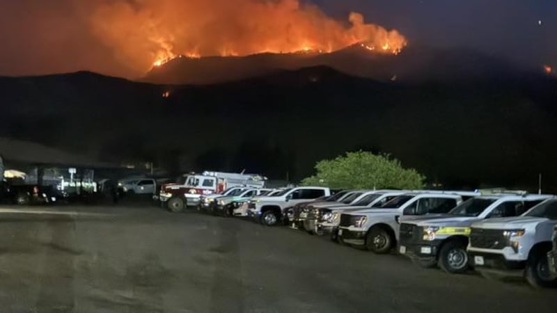 The Gold Mountain Fire burns atop Baldy Peak, seen from the Incident Command Post on July 5,...